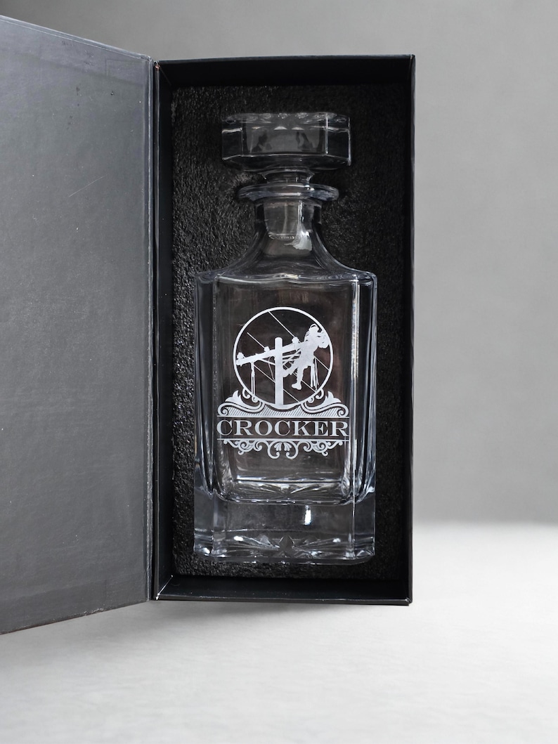 Personalized Lineman whiskey decanter engraved with the name Crocker, presented alone in a black gift box.
