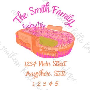 May include: A pink and orange illustration of a football stadium with the text "The Smith Family" above it and "rocky top" below it. The address "1234 Main Street Anywhere, State 12345" is printed below the stadium.
