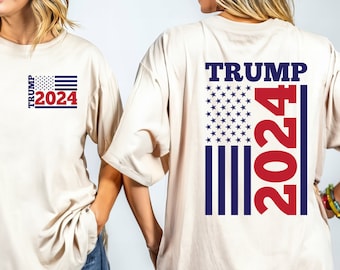 May include: Two people wearing beige t-shirts with a red, white, and blue American flag design and the text "TRUMP 2024".