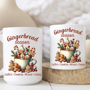 May include: Two white ceramic mugs with the words "Gingerbread season" in red script. The mugs feature a festive design of gingerbread cookies, candy canes, and greenery. The text "Latte's Cookies Bread Cakes" is also included.