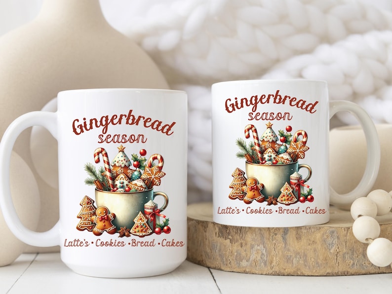 May include: Two white ceramic mugs with the words "Gingerbread season" in red script. The mugs feature a festive design of gingerbread cookies, candy canes, and greenery. The text "Latte's Cookies Bread Cakes" is also included.