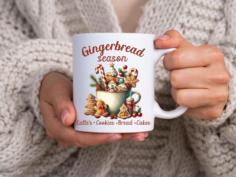 May include: White ceramic mug with a festive "Gingerbread season" design. The mug features a watercolor illustration of gingerbread cookies, candy canes, and a cup filled with treats. Text at the bottom reads "Latte's Cookies Bread Cakes."