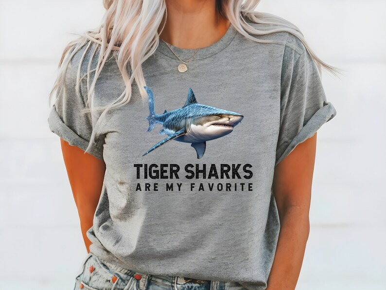 May include: A gray t-shirt with a blue tiger shark graphic and the text "Tiger Sharks Are My Favorite".