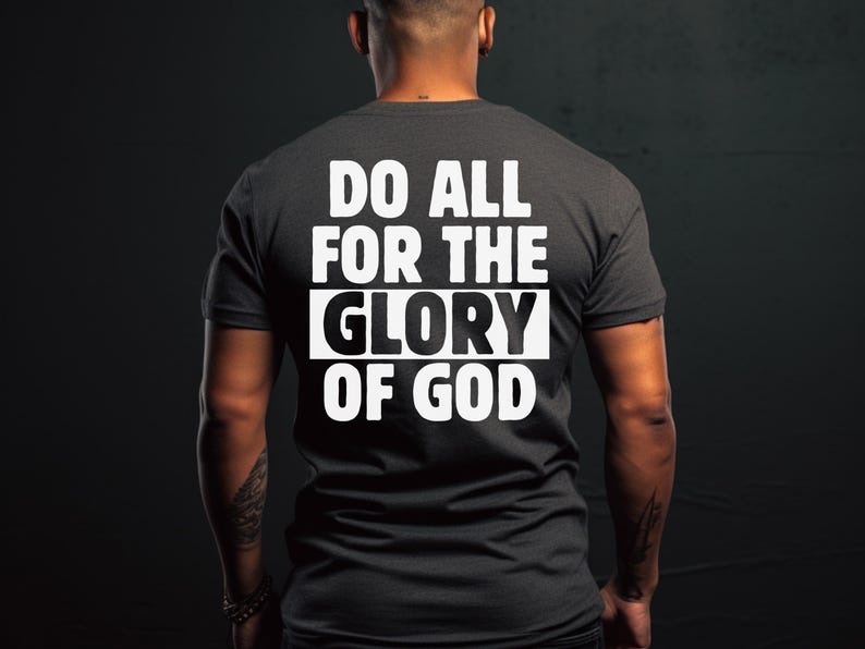 May include: A dark gray t-shirt with the text "Do All For The Glory Of God" printed in white on the back.