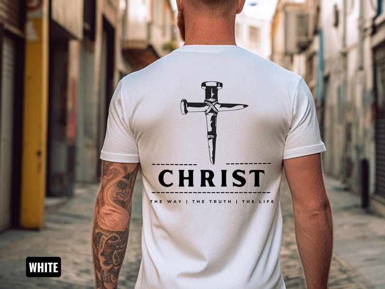 May include: White t-shirt with a black graphic of a nail hammered into a cross. The text "CHRIST" is below the graphic, and the text "THE WAY | THE TRUTH | THE LIFE" is below that.