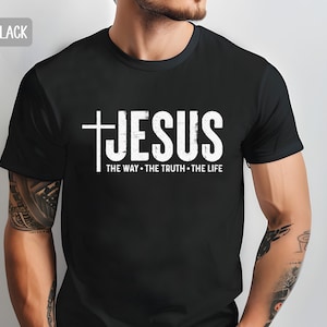 May include: Black t-shirt with a white graphic of a cross and the word "JESUS" with the text "THE WAY - THE TRUTH - THE LIFE" underneath.
