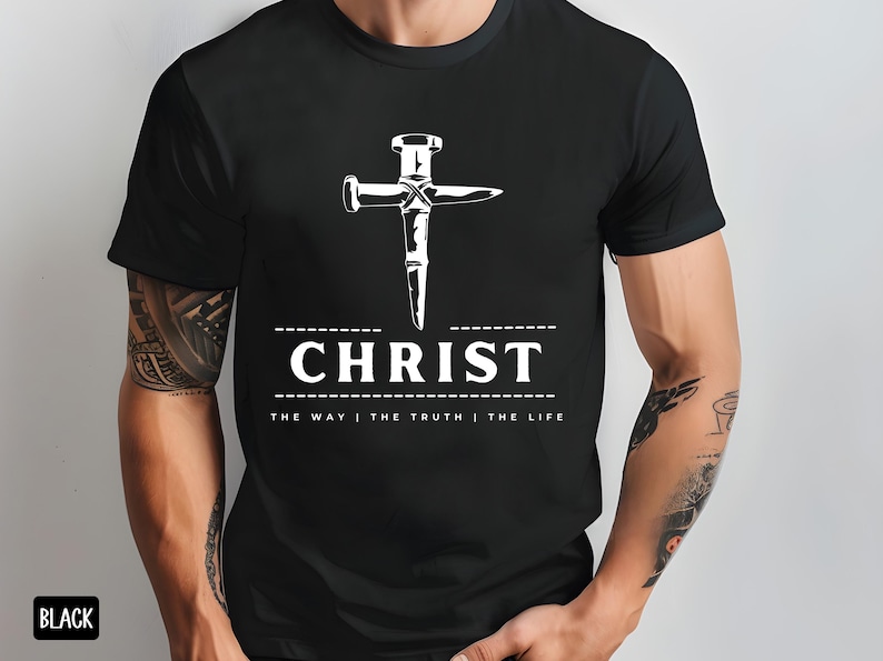 May include: Black t-shirt with a white graphic of a nail hammered into a cross. The text "CHRIST" is below the cross with the phrase "THE WAY | THE TRUTH | THE LIFE" underneath.