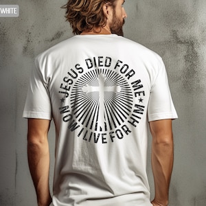 May include: White t-shirt with a black graphic print of a cross in a circle with the text "NOW I LIVE FOR HIM * JESUS DIED FOR ME *"