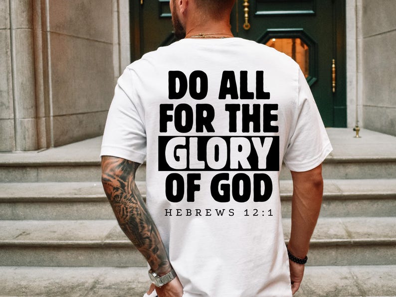May include: White t-shirt with black text that reads "Do all for the glory of God Hebrews 12:1".