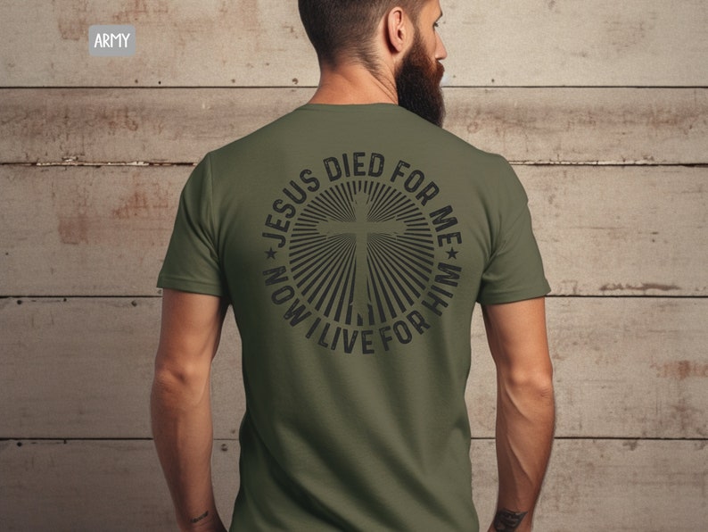 May include: A green t-shirt with a black graphic on the back. The graphic is a circle with a cross in the center and the text "Jesus Died For Me * Now I Live For Him".