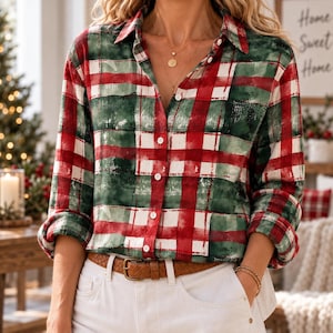 May include: A long-sleeve button-down shirt featuring a red, green, and white plaid pattern with a distressed, watercolor-like texture. The shirt has a classic collar, white buttons down the front, and is worn tucked into white pants with a brown belt.
