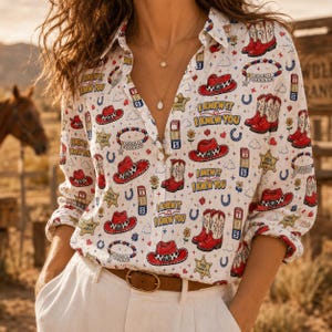 May include: A white long-sleeve button-down shirt featuring a repeating pattern of red cowboy hats, red cowboy boots, blue horseshoes, yellow sheriff stars, and the text I KNEW IT I KNEW YOU in blue and yellow lettering with a brown belt.