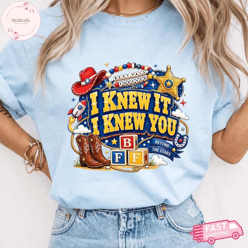 May include: A light blue t-shirt featuring a graphic print with the text I KNEW IT I KNEW YOU, a red cowboy hat, a gold sheriff star, a rocket, brown cowboy boots, and alphabet blocks labeled B, F, F, with a beaded necklace reading BEST PALS FOREVER.