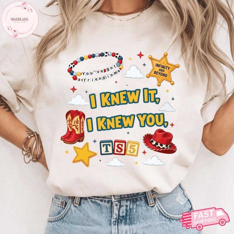 May include: A cream-colored t-shirt featuring a graphic print with the text "I KNEW IT, I KNEW YOU," a beaded bracelet with "You've got a friend in me," a sheriff star with "INFINITY AND BEYOND," red cowboy boots, a red hat, and "TS5" blocks.