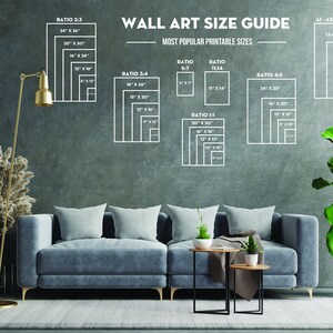 May include: A wall art size guide with different ratios and measurements in inches. The guide is displayed on a gray wall with a couch, two end tables, a floor lamp, and plants in the foreground.