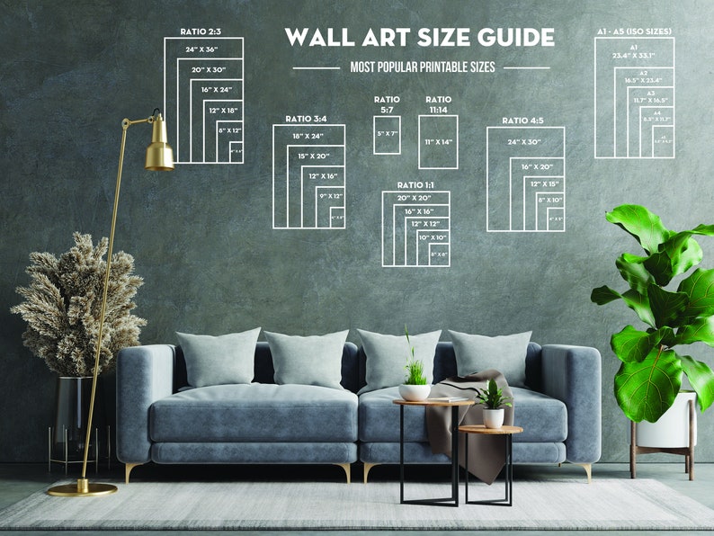 May include: A wall art size guide with different ratios and measurements in inches. The guide is displayed on a gray wall with a couch, two end tables, a floor lamp, and plants in the foreground.