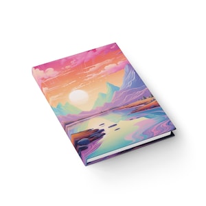 May include: A colorful notebook with a landscape scene of mountains, a lake, and a sunset. The cover features a vibrant pink, orange, and blue color scheme.