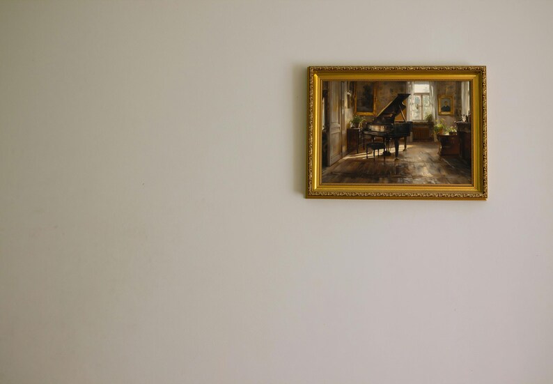 May include: A framed painting of a grand piano in a room with a window and a few pieces of furniture. The painting is in a gold frame with ornate details.