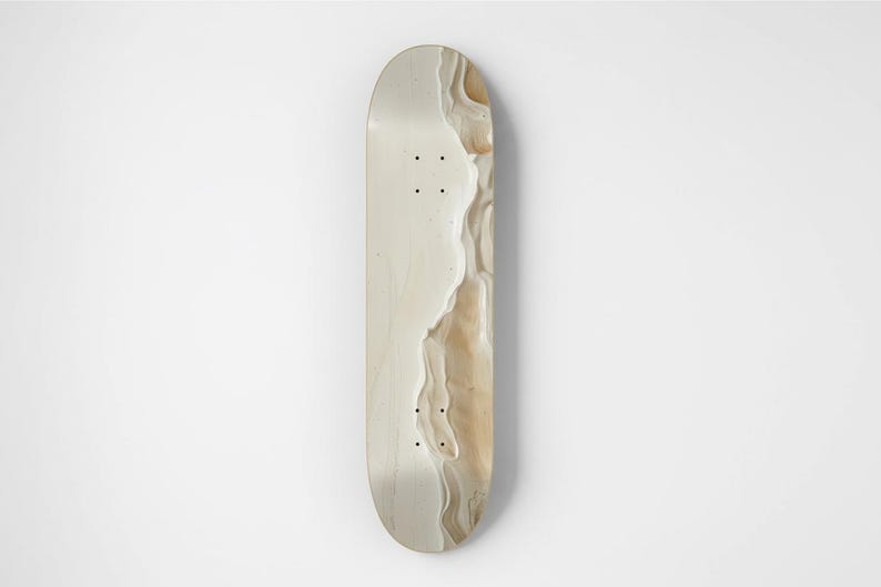 May include: A skateboard deck featuring a smooth, light cream-colored surface on the left side, transitioning into a textured, wavy pattern of beige and tan tones on the right side. The deck includes eight pre-drilled mounting holes.
