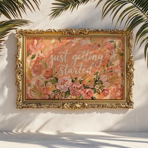 May include: A framed floral painting with the words "just getting started" in cursive script. The artwork features a gold ornate frame and a soft color palette of pinks, peaches, and greens. The painting is a decorative piece.