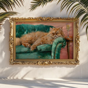 May include: A framed painting depicts a ginger Persian cat lounging on a green velvet sofa. The painting has a gold ornate frame. A glass of champagne sits on a small table next to the sofa. The background is a soft pink.