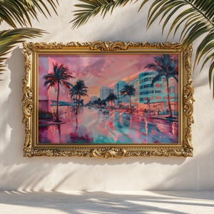 May include: A framed painting depicts a vibrant street scene with palm trees and buildings under a pink and orange sunset. The artwork is set in an ornate gold frame, creating a striking contrast.