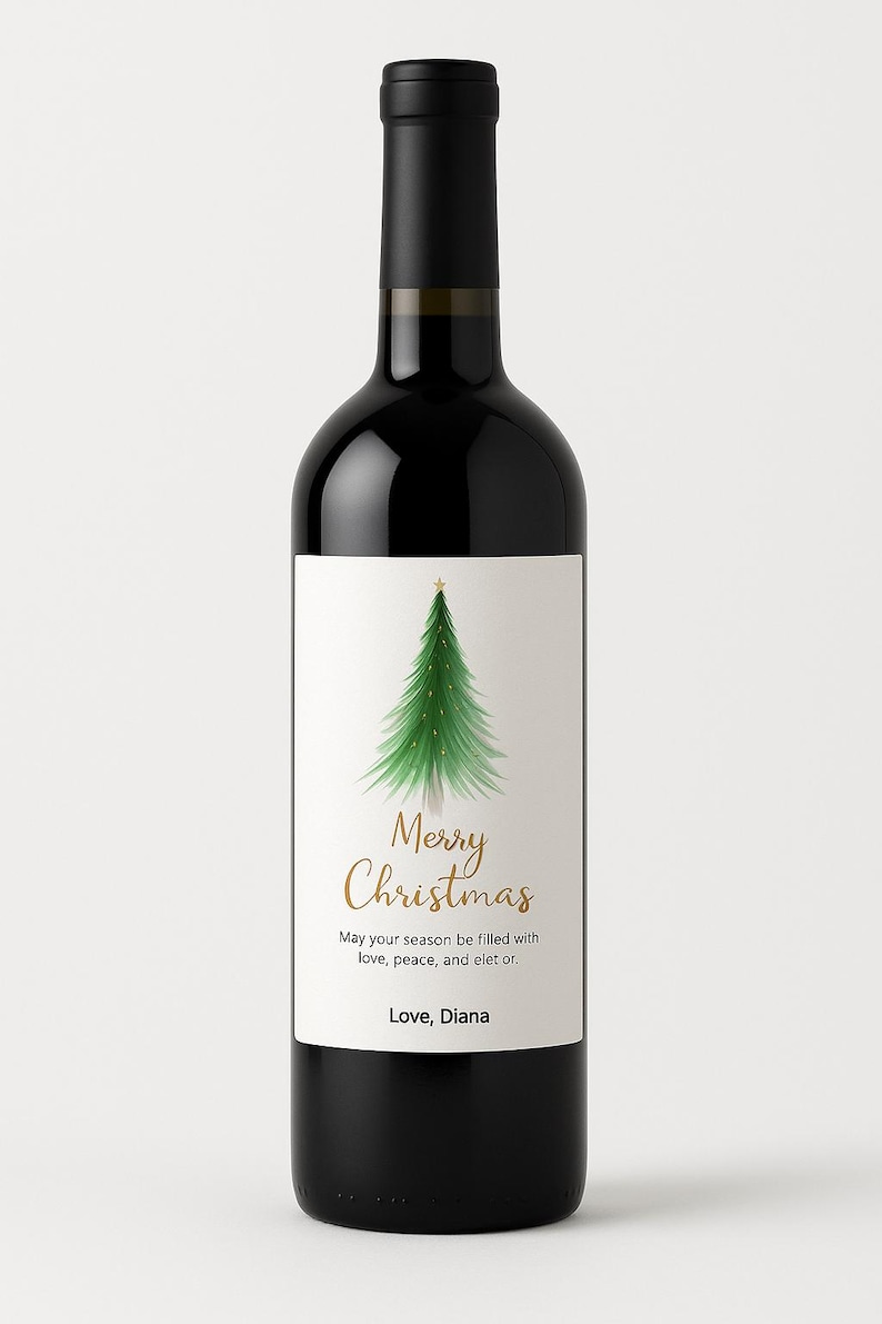 May include: A black wine bottle with a white label featuring a green Christmas tree illustration and the words "Merry Christmas" in gold script. The text "May your season be filled with love, peace, and elet or. Love, Diana" is also on the label.