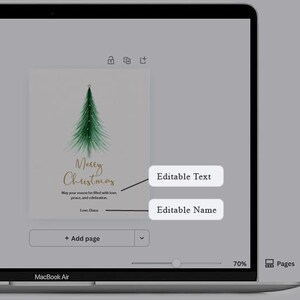 May include: A Christmas card design displayed on a MacBook Air screen. The card features a watercolor-style green Christmas tree and the words "Merry Christmas" in gold script. Below the text is the phrase "May your season be filled with love, peace, and celebration."