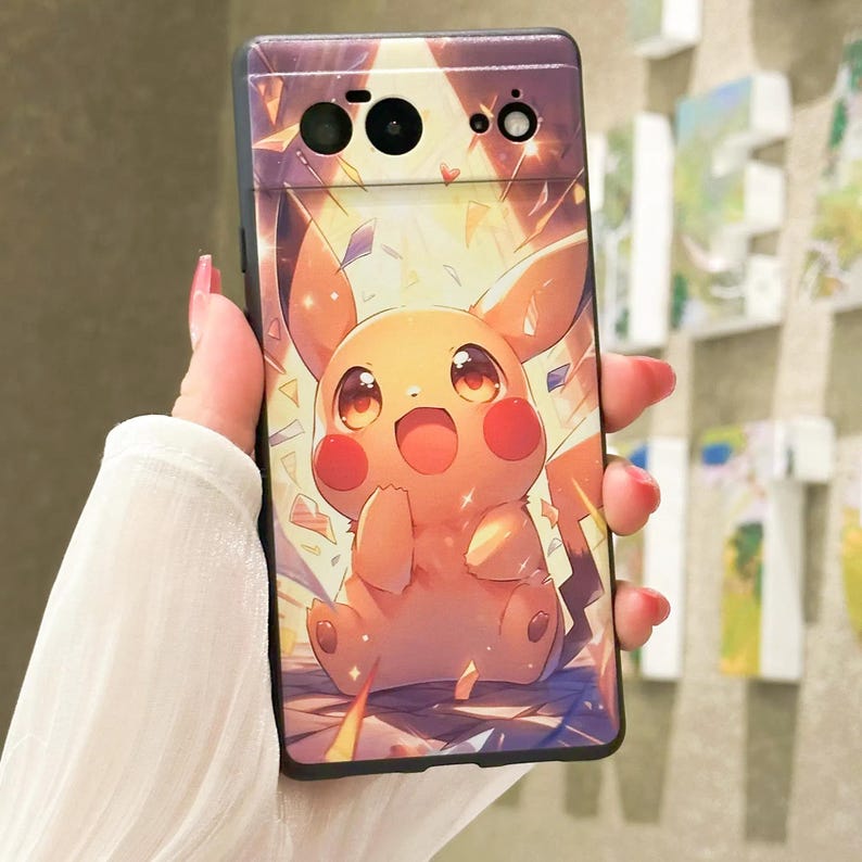 May include: A black phone case with a cartoon image of Pikachu, a yellow electric mouse Pok&eacute;mon, with a bright yellow background and sparkling effects.