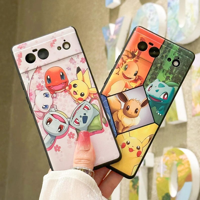 May include: Two phone cases featuring different Pokemon characters. The first case is pink with a floral pattern and features Pikachu, Bulbasaur, Squirtle, and other Pokemon. The second case is black and features a variety of Pokemon characters, including Eevee, Charmander, and Squirtle.