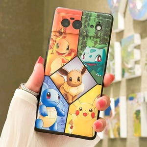 May include: A black phone case with a colorful Pokemon design. The case features a collage of different Pokemon characters, including Bulbasaur, Charmander, Squirtle, Eevee, and Pikachu.
