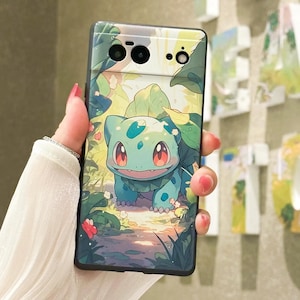 May include: A phone case with a green cartoon character on a green and brown background. The character has red eyes and a light blue body. The phone case has a black border.