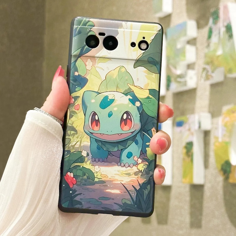 May include: A phone case with a green cartoon character on a green and brown background. The character has red eyes and a light blue body. The phone case has a black border.