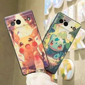 May include: Two phone cases with Pokemon characters. The case on the left features Pikachu in a yellow and orange design. The case on the right features Bulbasaur in a green and blue design.