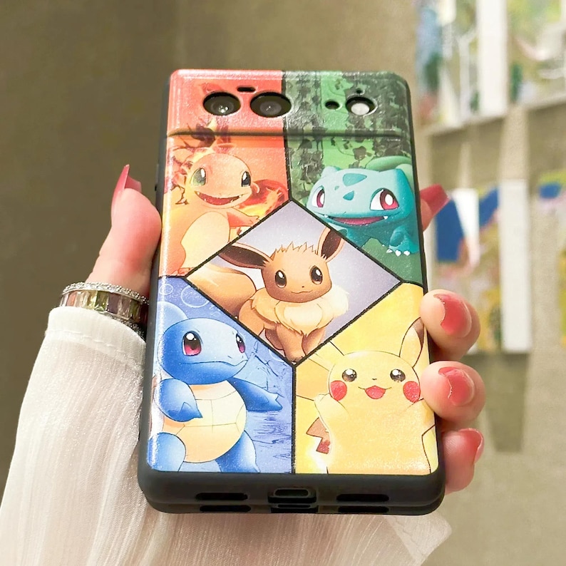 May include: A black phone case with a multi-colored design featuring various Pokemon characters. The case has a geometric pattern with each Pokemon character in a different colored section. The characters include Pikachu, Squirtle, Bulbasaur, Charmander, and Eevee.