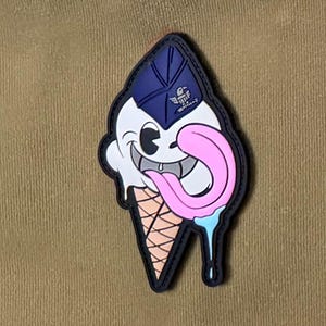 May include: A black and white cartoon ice cream cone with a pink tongue sticking out. The ice cream is wearing a blue and white pilot hat with a winged emblem. The ice cream is dripping blue and white.