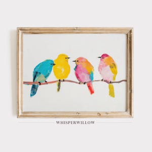 May include: A framed painting of four colorful birds perched on a branch. The birds are painted in shades of blue, yellow, pink, and orange. The painting is set against a white background and has a wooden frame.