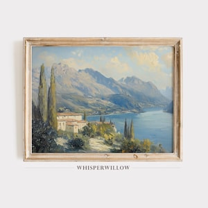 May include: A vintage oil painting depicting a picturesque landscape with a lake surrounded by mountains and a small village. The painting features a blue sky with white clouds, green trees, and a blue lake. The village is located on the shore of the lake and is surrounded by trees. The mountains are in the background and are covered in trees. The painting is framed in a light wood frame.