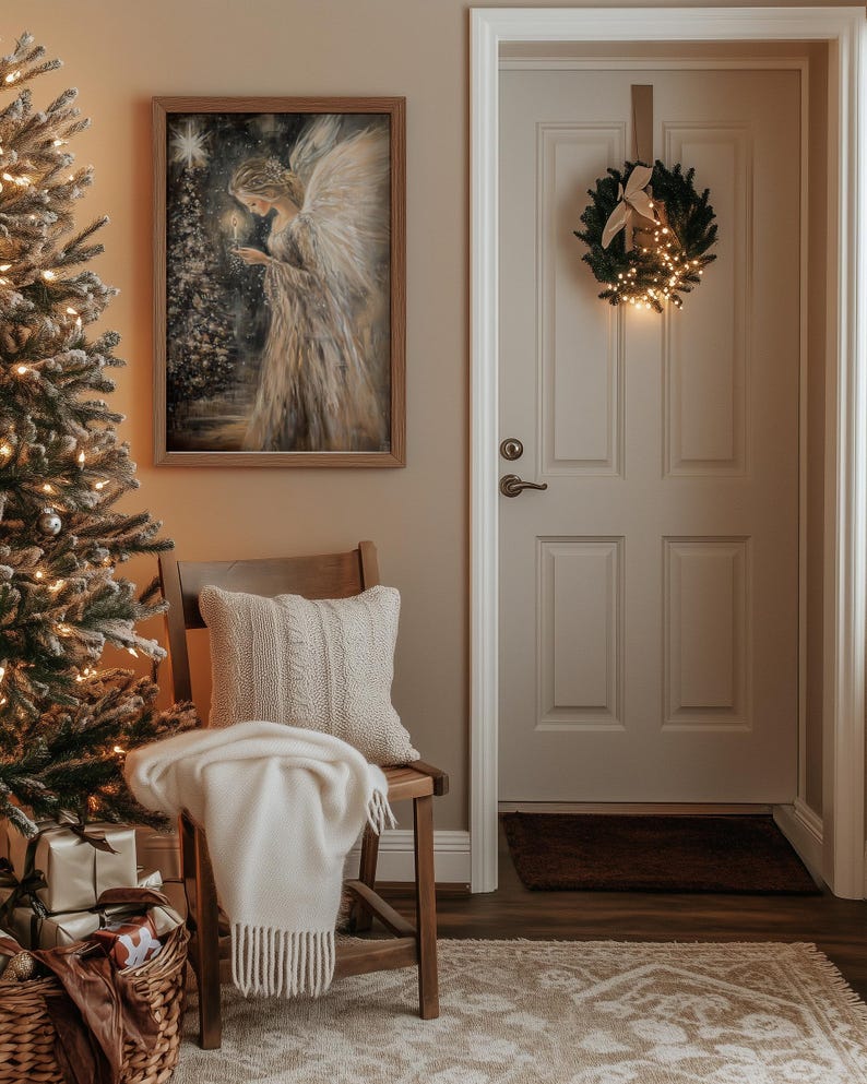 May include: A cosy living room with a Christmas tree, a chair with a white throw blanket, and a framed painting of an angel holding a candle. A wreath with lights hangs on the door.