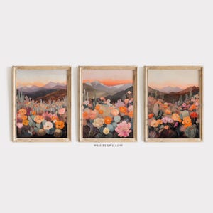 May include: Three framed prints depicting a desert landscape with a sunset in the background and a field of colourful flowers in the foreground. The prints are in a light wood frame.