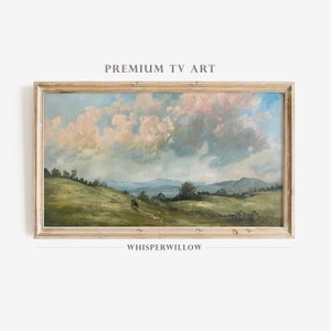 Pode incluir: Uma pintura emoldurada de uma paisagem com colinas onduladas, campos verdes e um céu nublado. A pintura está em uma moldura de madeira clara e tem o texto "WHISPERWILLOW" abaixo.