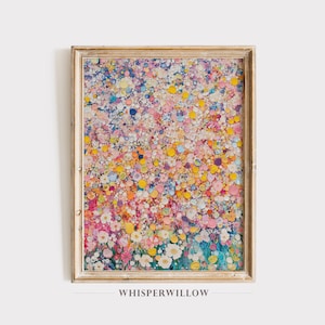 May include: A framed abstract painting with a colorful, textured design. The painting features a field of small, round shapes in shades of pink, yellow, blue, and white, creating a vibrant and whimsical effect.