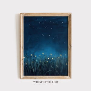 May include: A framed wall art print featuring a dark blue night sky filled with small white stars above a field of tall, dark grass illuminated by glowing yellow fireflies. The text WHISPERWILLOW is printed in a serif font below the frame.
