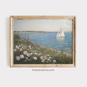 May include: A framed landscape painting featuring a coastal scene with a sailboat on blue water, a grassy shoreline filled with pink and white flowers, and a distant landmass under a pale sky. The text Whisper Willow is visible in the corner.