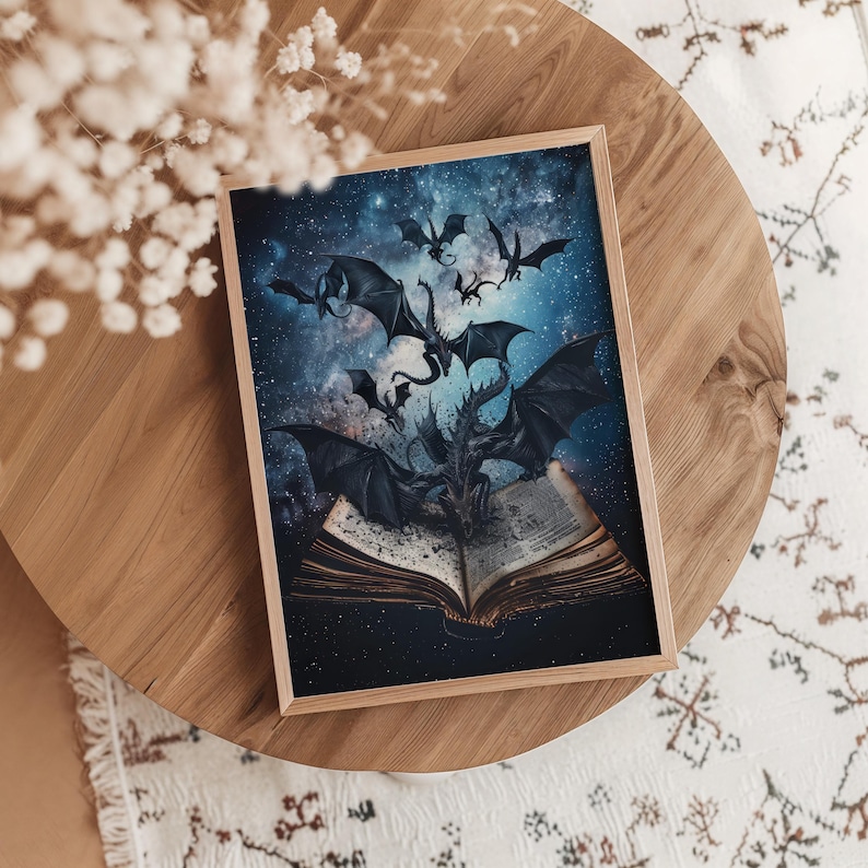 May include: A framed print of a fantasy illustration featuring five black dragons flying over a book with a starry night sky background.