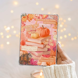 May include: A clear tablet case featuring a fall-themed design. The design includes pumpkins, books, and autumn leaves in shades of orange, pink, and yellow. Text includes "Pumpkin Spice and Cozy Nights" and "In My Cozy Girl Era."