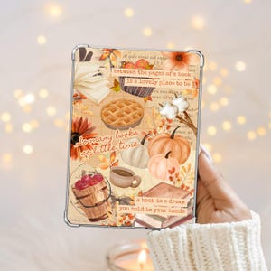 May include: A clear tablet case featuring a collage of autumn-themed illustrations including pumpkins, a pie, a bucket of apples, a coffee mug, and open books. The text reads: between the pages of a book is a lovely place to be, so many books so little time, a book is a dream you hold in your hands.