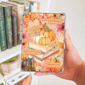 May include: A clear tablet case featuring an autumn-themed graphic with pumpkins, stacked books, and fall foliage. Text reads: Pumpkin spice and cozy nights, In my cozy girl era, Open a book step inside and disappear, The world belongs to those who read, A reader lives a thousand lives.