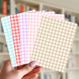 May include: A set of five rectangular cards featuring a classic gingham check pattern in various colours including light blue, red, purple, light pink, and beige. Each card has rounded corners and a consistent grid design across the entire surface.