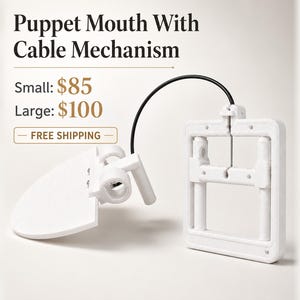 May include: A white puppet mouth mechanism featuring a rectangular frame connected by a black cable to a hinged jaw component. The text Puppet Mouth With Cable Mechanism is visible above the device, along with pricing for small and large sizes.